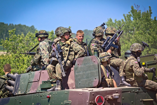 Drawsko Polmorskie, Poland - May 19, 2012:Polish infantry soldiers with Rosomak II - Contemporary Polish military battlefield transport vehicle during exercises on the military  training area in Drawsko Polmorskie