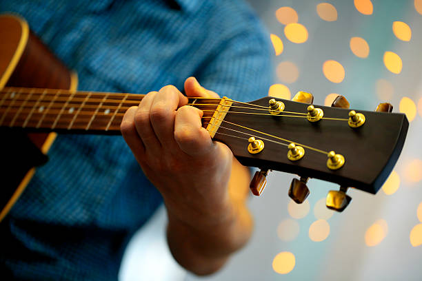 istock Man playing an acoustic guitar during a concert 482404148