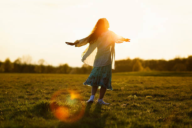 istock young woman on meadow sunset 482405605