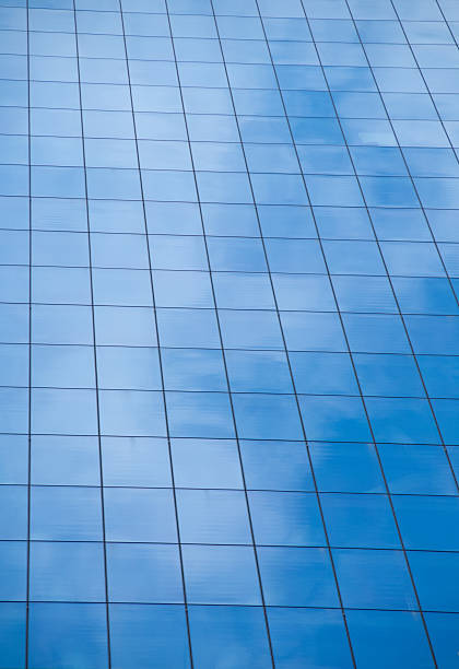 istock Reflection of blue sky on window glass office building 482405700