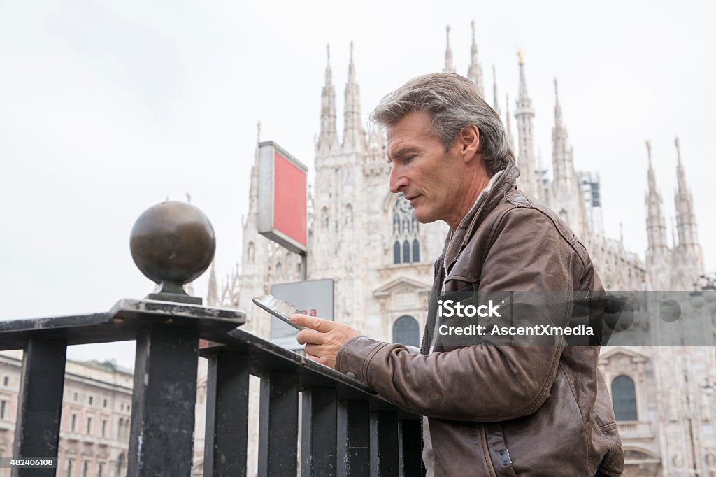 Man uses digital tablet in front of duomo, Milan 2015 Stock Photo