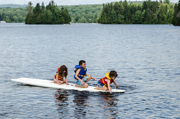 istock Little boys and girl on surf board 482406778