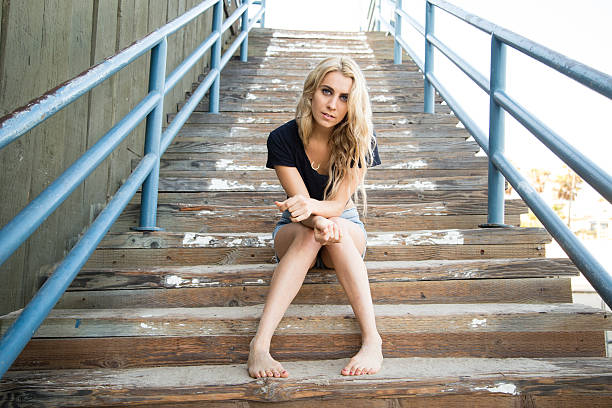 Woman on stairs at the pier. stock photo