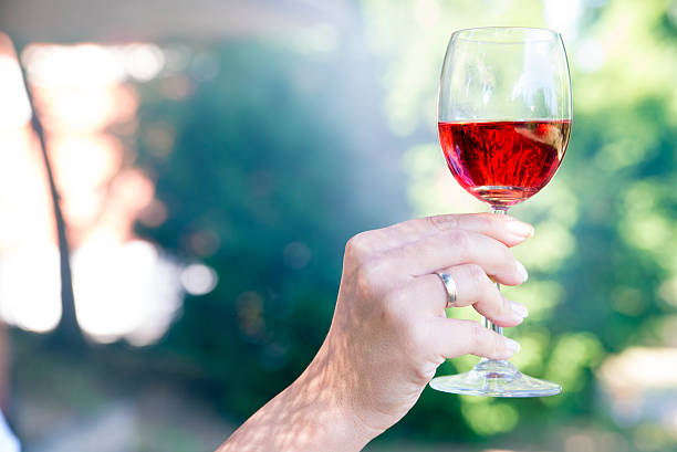 red wine glass with wine in the center of pictures
