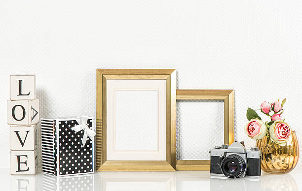 istock Golden picture frame, rose flowers and vintage camera. 482412868