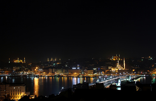 Istanbul, Turkey - November 12, 2012: mosques view with galata bridge, reflection on goldenhorn in night view of istanbul.