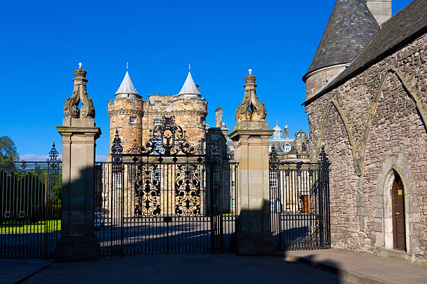 Edinburgh, United Kingdom - June 20, 2015: The Palace of Holyroodhouse, Edinburgh, Scotland, United Kingdom. The Palace of Holyroodhouse, commonly known as Holyrood Palace, is the official residence of the British monarch in Scotland. It is located at the bottom of the Royal Mile in Edinburgh, at the opposite end to Edinburgh Castle. Canon EF-S 10-22 mm f/3.5-5.6 lens. Deep blue sky with clouds is in background. The image is lit by evening sun.