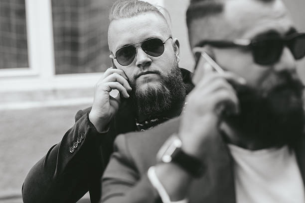 istock Two bearded businessman looking at phone 482417948