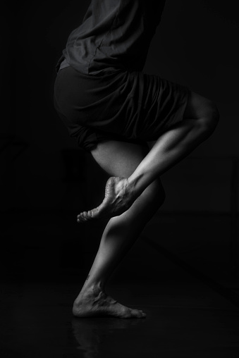 Woman Contemporary Dancer Legs and  Pointe , high contrast vignette Black and White in studio