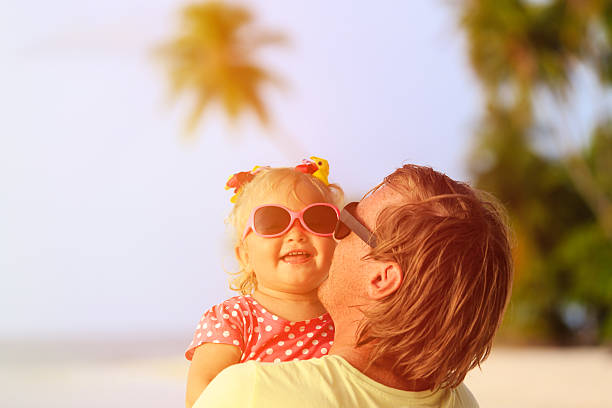 istock Happy father and cute little daughter at beach 482428182
