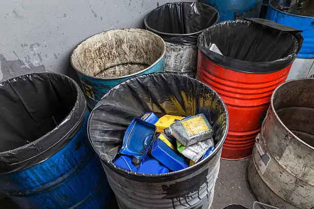 old bins of oil, used for trash arranged in rows