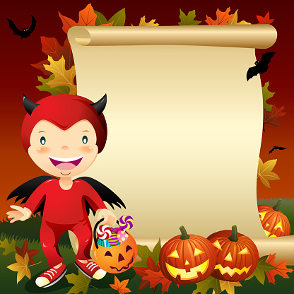 Little boy dress up devil costume in front of blank scroll on Halloween asking for candy or other treats.