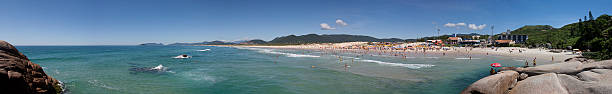 Joaquina beach panoramic view Florianopolis, Santa Catarina, Brazil - January 18, 2010: Panoramic view of a Brazilian beach called Joaquina located in Florianopolis city in Santa Catarina state with many tourists enjoying the clear sky and sunny day on it. joaquina beach in florianopolis santa catarina brazil stock pictures, royalty-free photos & images