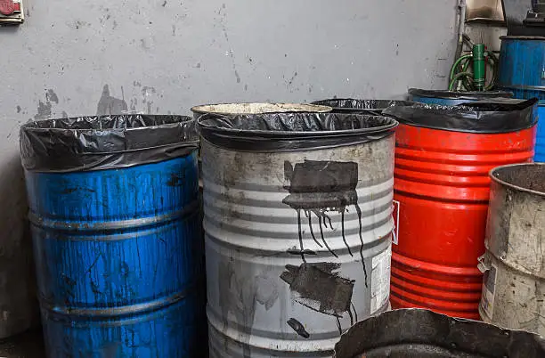 old bins of oil, used for trash arranged in rows