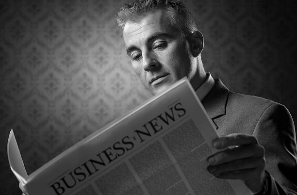 istock Businessman holding newspaper 482434079
