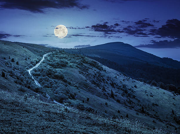 istock road through hillside in high mountains at night 482435726