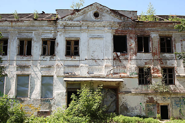 istock Big old brick burnt abandoned house with windows, general view 482436684