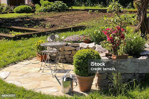 Iron Chair And Table In The Garden Stock Photo - Download Image Now - Arranging, Asphalt, Beauty In Nature