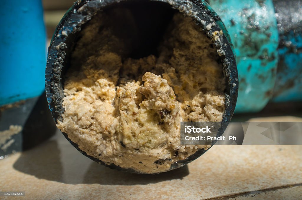 Pipe clogged with fats, oil and grease A pipe clogged with thick fats, oil and grease Clogged Stock Photo