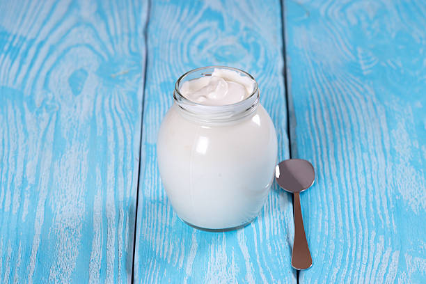 istock Bulgarian yogurt in a jar with a spoon. Blue background. 482440602
