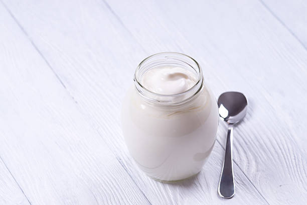 istock Low-fat yogurt in a glass jar. White background. 482440794