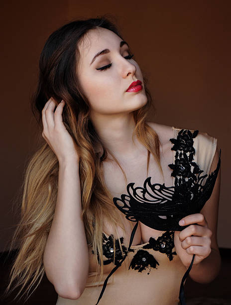 istock attractive mysterious young girl with black mask 482441538