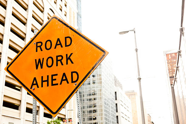 istock Road work ahead sign in downtown city. 482442356