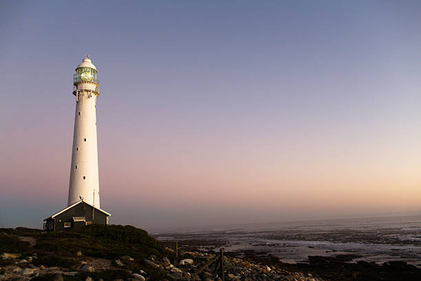 istock Lighthouse in a pink and blue sunset 482442416