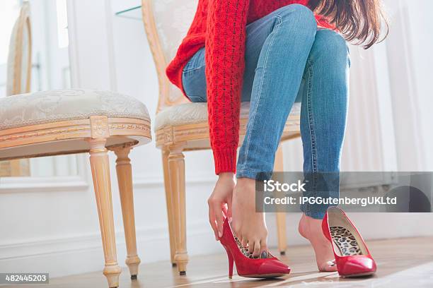 Low Section Of Woman Trying On Footwear In Store Stock Photo - Download Image Now - 20-24 Years, 20-29 Years, Adult