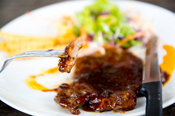 Grilled beef steak, French fries and vegetables