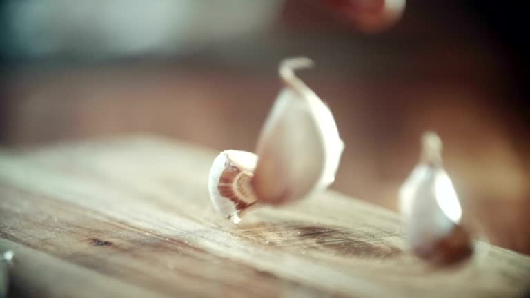 Crushing and Squeezing Garlic on Kitchen Board