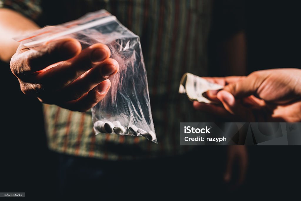 Selling illegal pills Dealer selling cocaine,ecstasy or other illegal drugs Crime Stock Photo