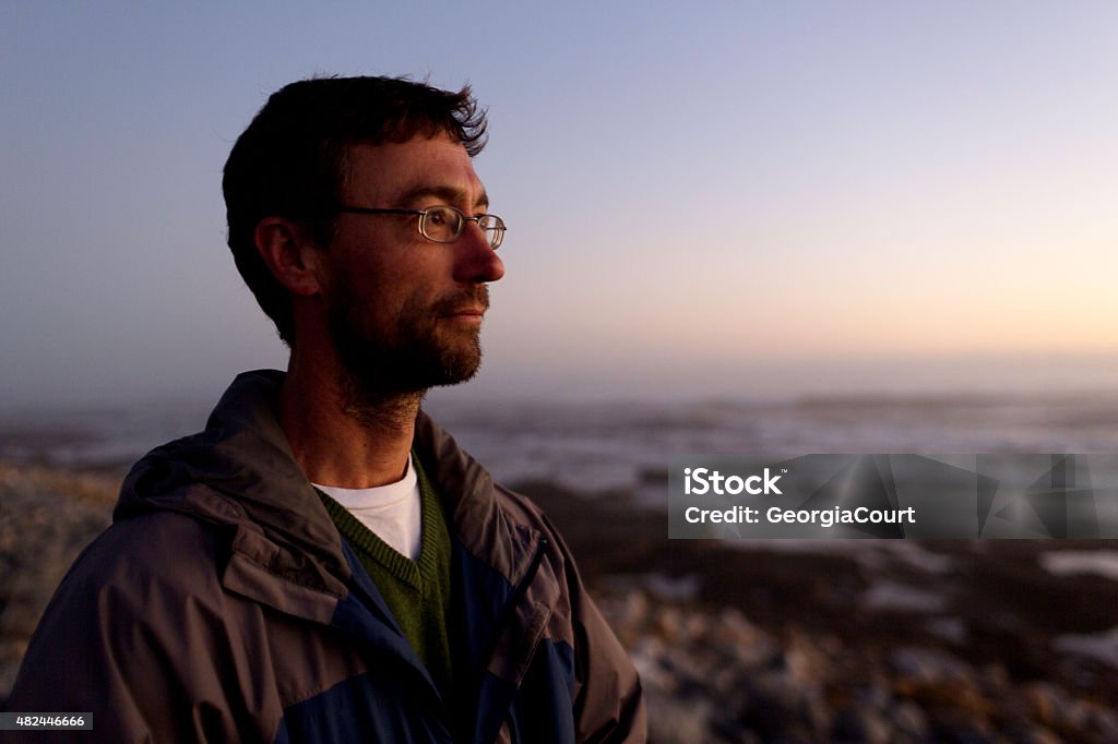 Portrait of a thinking man looking into sunset coastline A portrait of a man looking into the sunset. 2015 Stock Photo