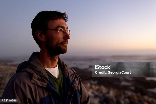 Portrait Of A Thinking Man Looking Into Sunset Coastline Stock Photo - Download Image Now
