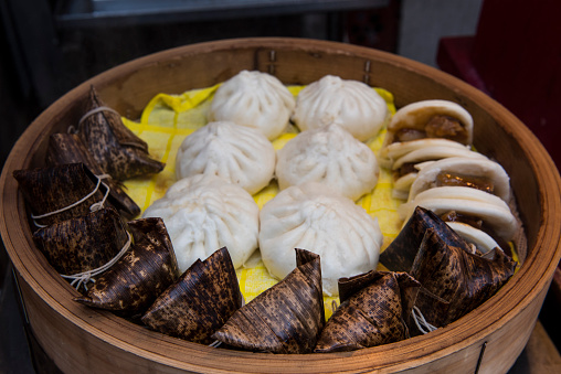 Chinese steamed bean buns and food wrapped in banana leaves