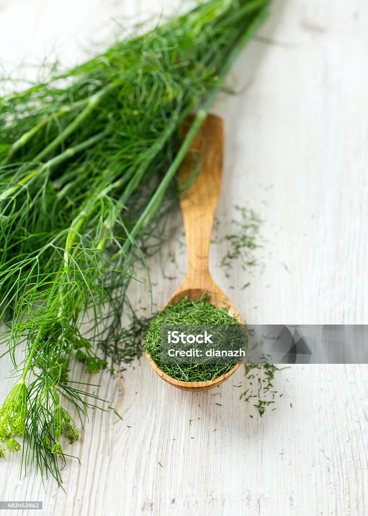 dried dill in a wooden spoon Dill Stock Photo