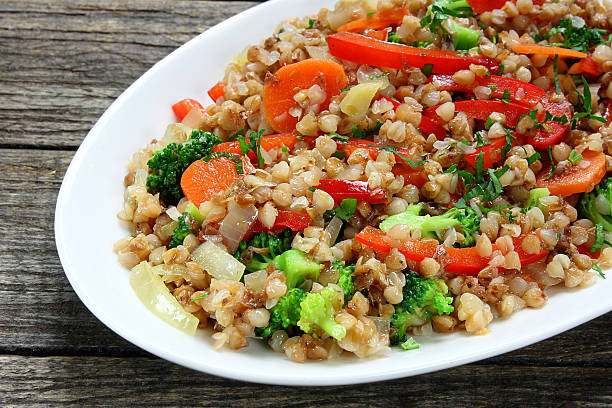 istock Buckwheat with carrots, onions, broccoli and paprika 482454227