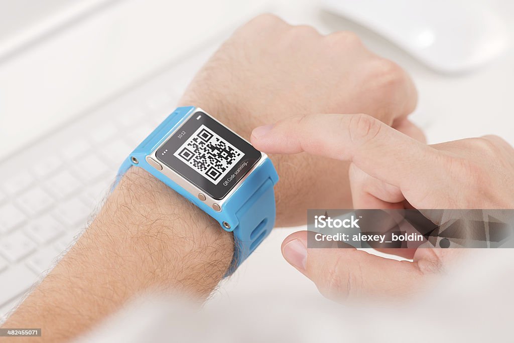 Scanning quick response code with smart watch Man is scanning quick response code with blue smart watch Bracelet Stock Photo