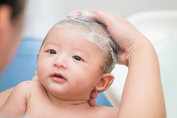 istock Mother give a bath her newborn baby, infant 482457016