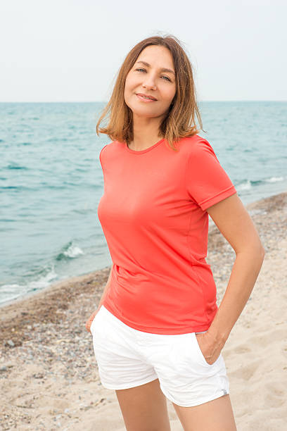 istock Woman walks by the sea 482457051