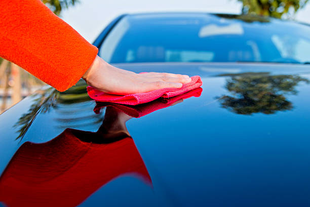 car polishing Woman hand polishing her car. waterless stock pictures, royalty-free photos & images