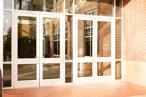 Business: Empty office building, school.  Front doors are closed. Out of business.  This empty office building has closed its doors due to economic depression.  Or school campus with no students. bank entrance stock pictures, royalty-free photos & images