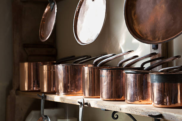istock row of gleaming copper saucepans in victorian kitchen 482458051