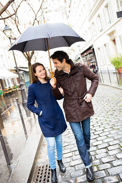 istock Handsome couple under the rain on street 482458097