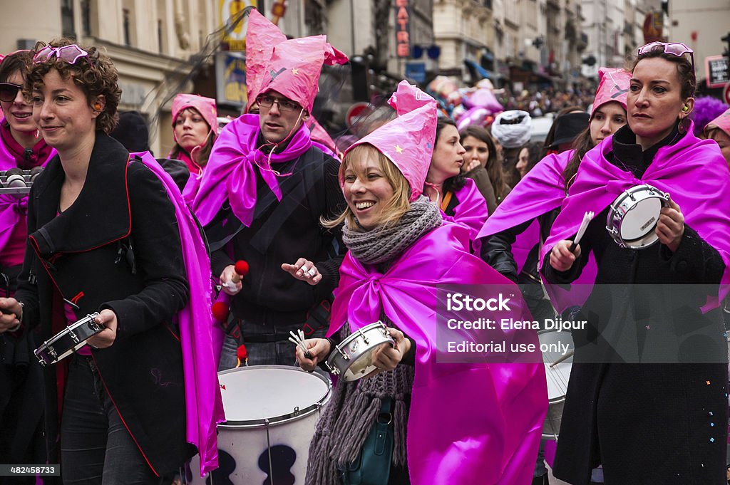 Music band in pink costumes at Carnival of Paris. Paris, France - March 2, 2014: Unidentified participants in pink costumes in the Carnival in Paris. Colorful Carnaval de Paris is annual event, which history starts from the sixteenth century. Activity Stock Photo