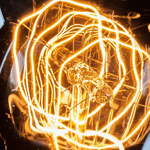 istock Closeup looping carbon filament of vintage edison light bulb. 482459498