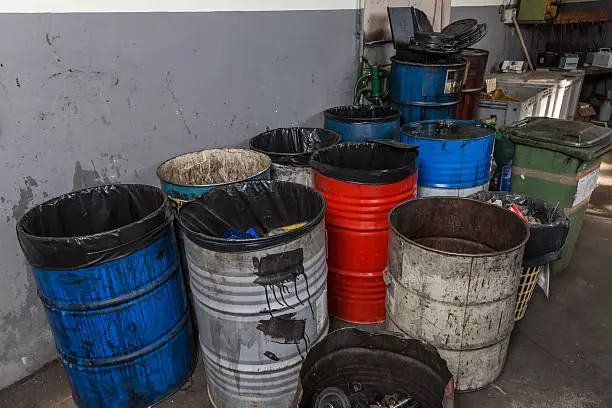 old bins of oil, used for trash arranged in rows