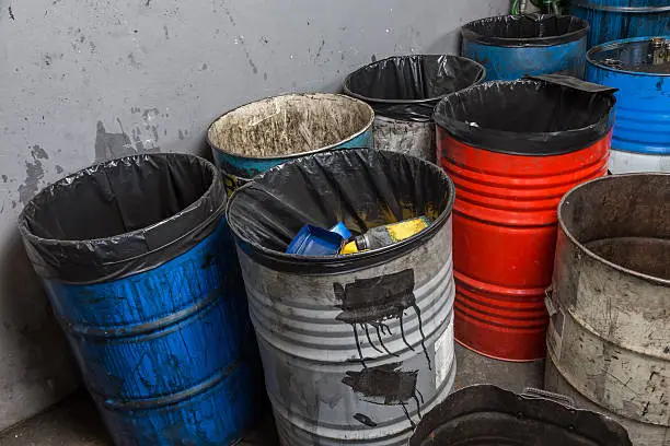 old bins of oil, used for trash arranged in rows