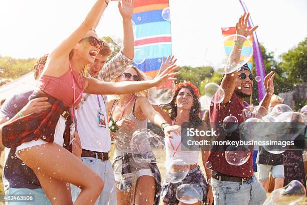 Friends Enjoying A Performance At A Music Festival Stock Photo - Download Image Now - 20-29 Years, 2015, Adult