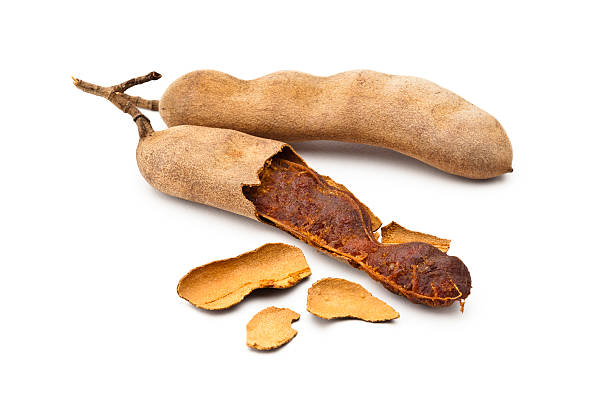 istock Two tamarind beans isolated on white background 482463544